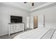 A bedroom with neutral colors, a large dresser, and two door ways at 631 Avondale Creek Dr, Decatur, GA 30032