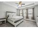 A lovely bedroom with a ceiling fan and a large bed with storage underneath at 631 Avondale Creek Dr, Decatur, GA 30032