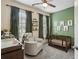 A charming Bedroom with a crib, accent wall, and a comfortable chair at 631 Avondale Creek Dr, Decatur, GA 30032