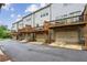 Backside of townhomes showing garage doors and wooden decks at 631 Avondale Creek Dr, Decatur, GA 30032