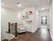 Bright hallway with hardwood floors, a comfortable chair, and decorative shelving at 631 Avondale Creek Dr, Decatur, GA 30032