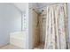 Bathroom featuring a tub and tiled shower at 174 Saint Georges Ct, Suwanee, GA 30024