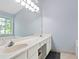 Bathroom featuring double sinks and a large mirror at 174 Saint Georges Ct, Suwanee, GA 30024
