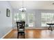 Sunlit dining area with hardwood floors and views of the outdoors at 174 Saint Georges Ct, Suwanee, GA 30024
