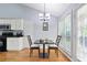 Cozy dining area featuring natural light and hardwood floors at 174 Saint Georges Ct, Suwanee, GA 30024
