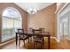 Dining room showcases a high ceiling, hardwood floors, and a large window at 174 Saint Georges Ct, Suwanee, GA 30024