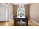 Formal dining room featuring textured walls, hardwood floors, a large window, and chandelier at 174 Saint Georges Ct, Suwanee, GA 30024