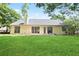 Exterior back view highlighting the home's spacious backyard at 174 Saint Georges Ct, Suwanee, GA 30024