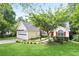 Inviting single-story home with a manicured lawn, red door, and two car garage at 174 Saint Georges Ct, Suwanee, GA 30024