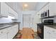 Bright kitchen with white cabinets, granite countertops, and stainless steel appliances at 174 Saint Georges Ct, Suwanee, GA 30024