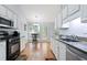Bright kitchen with white cabinets, granite countertops, stainless steel appliances, and breakfast nook at 174 Saint Georges Ct, Suwanee, GA 30024