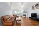 Living room features vaulted ceilings, hardwood floors, a fireplace, and large windows at 174 Saint Georges Ct, Suwanee, GA 30024