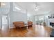 Open living room featuring hardwood floors, vaulted ceilings, and a fireplace at 174 Saint Georges Ct, Suwanee, GA 30024
