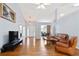 Spacious living room with hardwood floors, vaulted ceilings, and views into the dining area at 174 Saint Georges Ct, Suwanee, GA 30024
