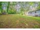 Expansive backyard with mature trees surrounding a well-maintained lawn, offering ample space at 3731 Adkins Nw Rd, Atlanta, GA 30331