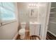 Bright bathroom features a white vanity, decorative mirror, and wood-look floors at 3731 Adkins Nw Rd, Atlanta, GA 30331