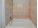 This bathroom features tile walls and a white tub at 3731 Adkins Nw Rd, Atlanta, GA 30331