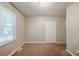 Vacant bedroom with large window, carpeted floors and closet at 3731 Adkins Nw Rd, Atlanta, GA 30331