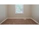 Empty bedroom with neutral walls, brown carpet and natural light at 3731 Adkins Nw Rd, Atlanta, GA 30331