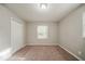 Bedroom featuring tan walls, brown carpet, natural light, and closet at 3731 Adkins Nw Rd, Atlanta, GA 30331