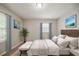 Staged bedroom featuring a bed, ottoman, carpet and natural light at 3731 Adkins Nw Rd, Atlanta, GA 30331