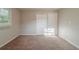 Empty bedroom with tan walls, brown carpet, natural light and closet at 3731 Adkins Nw Rd, Atlanta, GA 30331