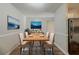 Staged dining room with natural light, wood table, rug, and modern decor at 3731 Adkins Nw Rd, Atlanta, GA 30331