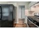 Functional kitchen with stainless steel appliances and newly installed plank flooring at 3731 Adkins Nw Rd, Atlanta, GA 30331