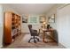 Home office with bookcase, desk, natural light, tan walls, and brown carpet at 3731 Adkins Nw Rd, Atlanta, GA 30331