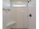 Elegant tiled shower featuring a built-in bench, window and bronze fixtures at 4230 Old Cherokee St, Acworth, GA 30101