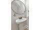 Charming powder room with pedestal sink, bronze fixtures, round mirror and shiplap walls at 4230 Old Cherokee St, Acworth, GA 30101