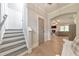 Bright foyer with hardwood floors, staircase, and views into the living room at 4230 Old Cherokee St, Acworth, GA 30101