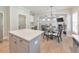 Open floor plan showing kitchen island, dining area with chairs and a view into the open living room at 4230 Old Cherokee St, Acworth, GA 30101