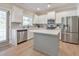 Bright kitchen features white cabinets, stainless steel appliances, backsplash and a center island with light hardwood floors at 4230 Old Cherokee St, Acworth, GA 30101