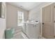Efficient laundry room with modern washer and dryer, and natural light from the window at 4230 Old Cherokee St, Acworth, GA 30101