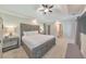 Bright main bedroom features a tray ceiling, a ceiling fan, carpet and an ensuite bathroom at 4230 Old Cherokee St, Acworth, GA 30101