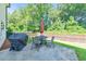 Cozy backyard patio features an outdoor dining table set, grill, and privacy fence at 4230 Old Cherokee St, Acworth, GA 30101