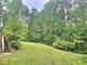 View of the home's backyard and surrounding trees at 4855 West Price Rd, Sugar Hill, GA 30518