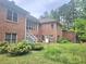 View of the brick home's backyard and screened in porch at 4855 West Price Rd, Sugar Hill, GA 30518