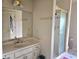 Bathroom features a single sink vanity, large mirror, and standing shower at 4855 West Price Rd, Sugar Hill, GA 30518