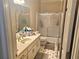 Bathroom features a single sink vanity, frosted sliding shower door and linoleum flooring at 4855 West Price Rd, Sugar Hill, GA 30518