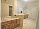 Large bathroom with double vanity, tile floors, and separate shower at 4855 West Price Rd, Sugar Hill, GA 30518