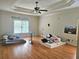 Bedroom features hardwood floors, ceiling fan and natural light at 4855 West Price Rd, Sugar Hill, GA 30518