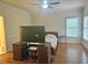 Bedroom with hardwood floors, natural light, and built in desk at 4855 West Price Rd, Sugar Hill, GA 30518