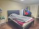 Bedroom with hardwood floors, bed and clothing rack at 4855 West Price Rd, Sugar Hill, GA 30518
