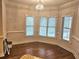 Breakfast nook with hardwood floors, chair railing, and lots of natural light from three windows at 4855 West Price Rd, Sugar Hill, GA 30518