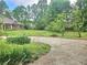Circular driveway with lush greenery on a large private lot at 4855 West Price Rd, Sugar Hill, GA 30518