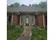 Front entrance of brick home featuring a charming front door and elegant exterior details at 4855 West Price Rd, Sugar Hill, GA 30518