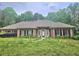 Charming one-story brick home featuring a well-manicured front yard and a welcoming entrance at 4855 West Price Rd, Sugar Hill, GA 30518