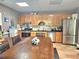 Traditional kitchen features wooden cabinets, granite countertops, and stainless steel appliances at 4855 West Price Rd, Sugar Hill, GA 30518